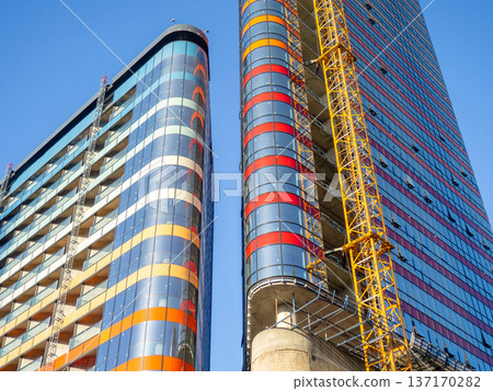 Modern construction of a high-rise building. Modern architecture of a business center. Apartment in a high-rise building. Modern construction of a high-rise building. Modern architecture of a business center. Apartment in a high-rise building. 137170282