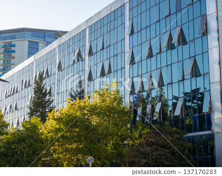 Glazed house with open windows. Facade of an office building. 137170283
