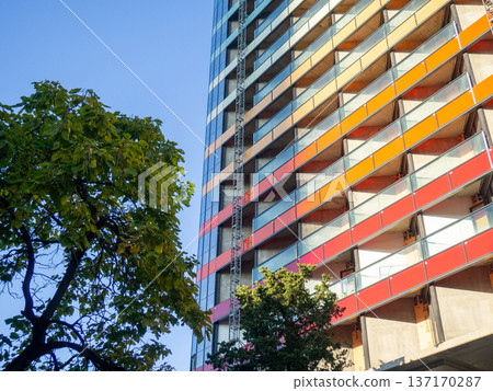 Modern construction of a high-rise building. Modern architecture of a business center. Apartment in a high-rise building. Modern construction of a high-rise building. Modern architecture of a business center. Apartment in a high-rise building. 137170287