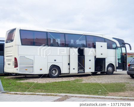 A Mercedes Benz bus is preparing to depart. Loading things onto the bus. Motor transport industry. Open doors A Mercedes Benz bus is preparing to depart. Loading things onto the bus. Motor transport industry. Open doors 137170296