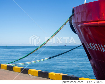 Moored ship in the port. Mooring on a bollard. The ship is parked. Moored ship in the port. Mooring on a bollard. The ship is parked. 137170876