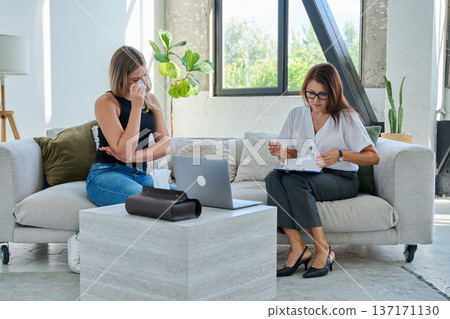 Sad crying young woman patient in therapy session in psychologist office 137171130