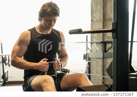 Man doing cable row exercise in gym Man doing cable row exercise in gym 137171167