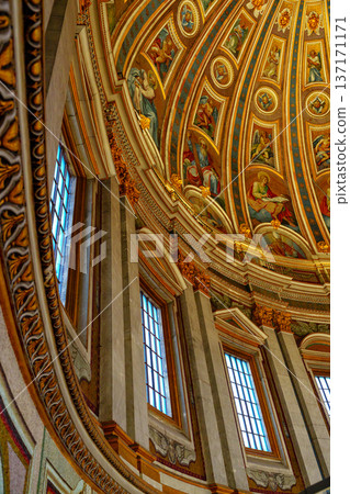 Beautiful ceiling design in a historic church with bright windows and detailed art work 137171171