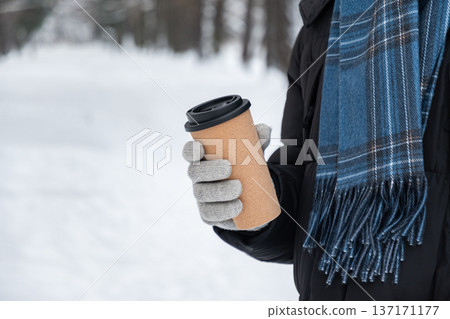 Close up of reusable coffee cup in winter hands Close up of reusable coffee cup in winter hands 137171177