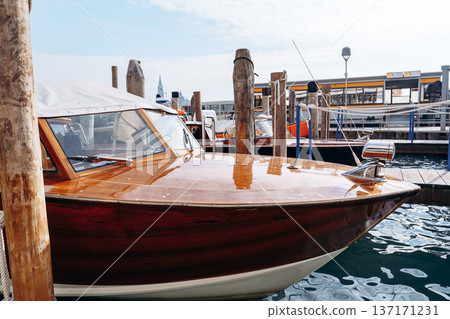 Wooden boat docked at a marina during daytime in a coastal area Wooden boat docked at a marina during daytime in a coastal area 137171231
