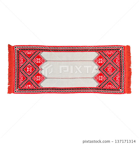 Embroidered towel showing traditional red and black patterns 137171314