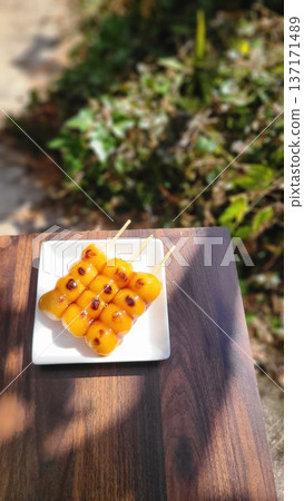 Three mitarashi dango served on a white plate Three mitarashi dango served on a white plate 137171489