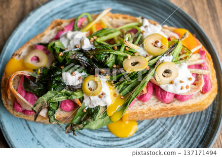 Breakfast served. Delicious bruschetta. Healthy veggie toast with beetroot food. Runny creamy sauce with grilled greens herbs on bread. Breakfast served. Delicious bruschetta. Healthy veggie toast with beetroot food. Runny creamy sauce with grilled greens herbs on bread. 137171494