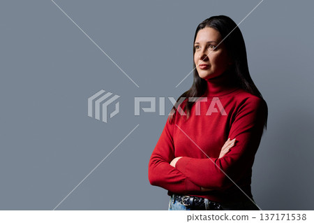 Profile portrait of beautiful confident 40 years old woman in red sweater on gray background 137171538