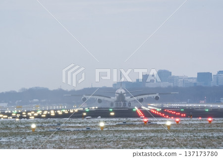 Rear perspective of a commercial jet touching down in winter conditions Rear perspective of a commercial jet touching down in winter conditions 137173780