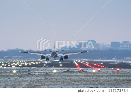 Rear view of a large airplane after landing on a snow covered airfield Rear view of a large airplane after landing on a snow covered airfield 137173784