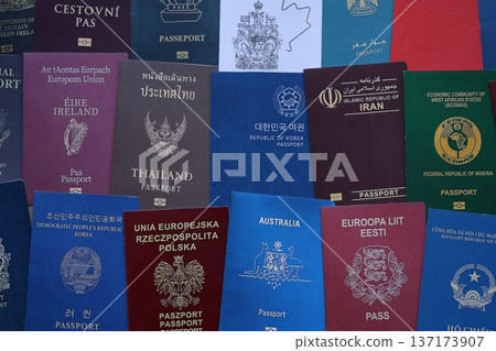 Big amount of passports of various different countries. Covers of expired passports close up. Travel documents for tourism 137173907