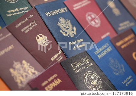 Big amount of passports of various different countries. Covers of expired passports close up. Travel documents for tourism Big amount of passports of various different countries. Covers of expired passports close up. Travel documents for tourism 137173916