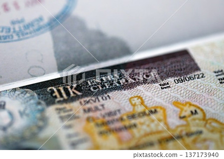 United Kingdom UK entry clearance visa in passport close up view. British visa in passport close up United Kingdom UK entry clearance visa in passport close up view. British visa in passport close up 137173940