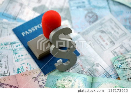 Paragraph symbol and stamp on passport pages full of colorful stamp prints after travel and tourism. Border control and lawsuit concept. Immigration and travel around the world Paragraph symbol and stamp on passport pages full of colorful stamp prints after travel and tourism. Border control and lawsuit concept. Immigration and travel around the world 137173953