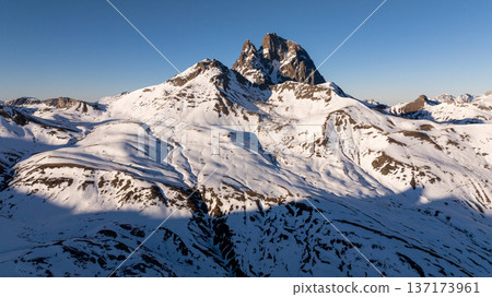 Detailed view of the iconic rocky twin peaks surrounded by white snowy slopes Detailed view of the iconic rocky twin peaks surrounded by white snowy slopes 137173961