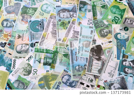 Various currencies money bills banknotes in green color. Many cash bills from different countries in big pile close up. World economy and currency exchange concept 137173981