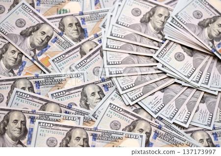 Big pile of new USD hundred dollar bills. Currency of United States of America in big amount. US one hundred bucks banknotes. Rich life concept, business and economy Big pile of new USD hundred dollar bills. Currency of United States of America in big amount. US one hundred bucks banknotes. Rich life concept, business and economy 137173997