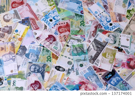 Different banknotes from many currencies of the whole world. Big pile of money bills close up 137174001