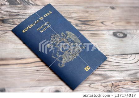 Chile Republic passport lies on wooden table close up. Chilean blue new passport book in details Chile Republic passport lies on wooden table close up. Chilean blue new passport book in details 137174017