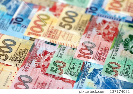 Big pile of Hong Kong dollars money bills banknotes close up. Lots of money of Chinese Hong Kong HKD currency cash in big bunch. Economics and business in HongKong Big pile of Hong Kong dollars money bills banknotes close up. Lots of money of Chinese Hong Kong HKD currency cash in big bunch. Economics and business in HongKong 137174021