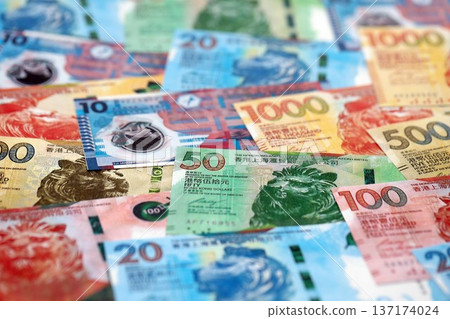 Big pile of Hong Kong dollars money bills banknotes close up. Lots of money of Chinese Hong Kong HKD currency cash in big bunch. Economics and business in HongKong Big pile of Hong Kong dollars money bills banknotes close up. Lots of money of Chinese Hong Kong HKD currency cash in big bunch. Economics and business in HongKong 137174024