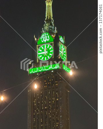 Mecca clock tower at night with illuminated green clock face on Abraj Al Bait tower Mecca clock tower at night with illuminated green clock face on Abraj Al Bait tower 137174081