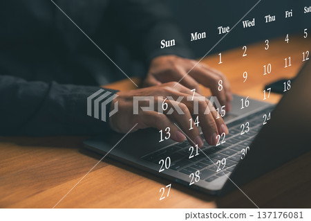 Hand typing on laptop with virtual calendar dates, representing online scheduling, time management, business planning, deadline organization, productivity workflow, and digital work efficiency concept 137176081