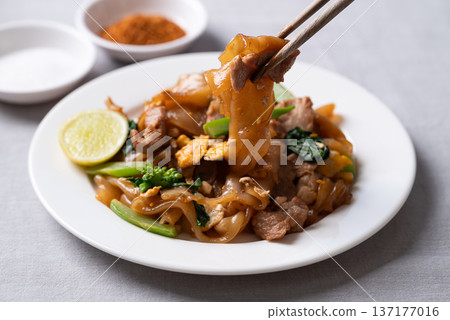 Thai food (Pad See Ew), Stir-fried rice noodles with soy sauce, pork, egg, and kale 137177016
