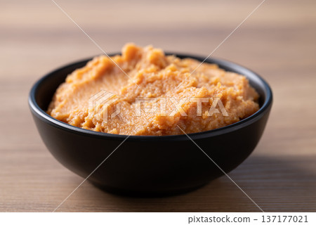 Miso paste in a black bowl on a rustic wooden table Miso paste in a black bowl on a rustic wooden table 137177021