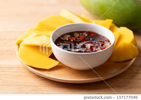 Fresh sliced mangoes eating with Thai sweet fish sauce (Nam Pla Wan) Fresh sliced mangoes eating with Thai sweet fish sauce (Nam Pla Wan) 137177046