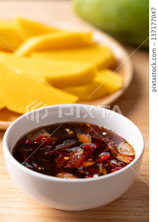 Fresh sliced mangoes eating with Thai sweet fish sauce (Nam Pla Wan) Fresh sliced mangoes eating with Thai sweet fish sauce (Nam Pla Wan) 137177047