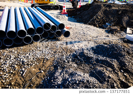 Construction site: Piping materials and excavator b-2 High saturation contrast Construction site: Piping materials and excavator b-2 High saturation contrast 137177851