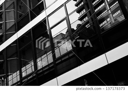 Monochrome cityscape: Cityscape reflected in glass buildings Monochrome cityscape: Cityscape reflected in glass buildings 137178373