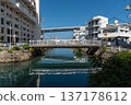 A pedestrian bridge crossing a river in Okinawa and the Tomari Ohashi Bridge crossing the sea 137178612
