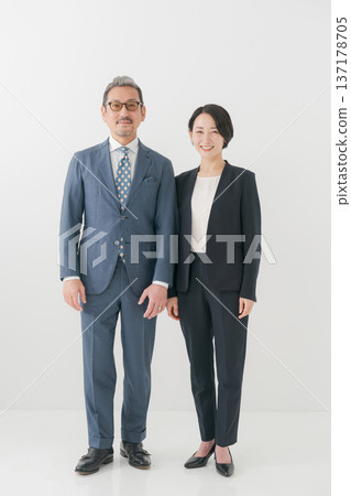 Male and female middle-aged business people Male and female middle-aged business people 137178705