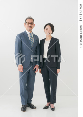 Male and female middle-aged business people Male and female middle-aged business people 137178706