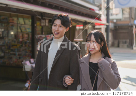 A smiling couple walking arm in arm through the tourist area of Shibamata A smiling couple walking arm in arm through the tourist area of Shibamata 137178734
