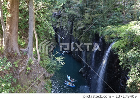 (Takachiho Gorge) A river in a valley with a small waterfall (Takachiho Gorge) A river in a valley with a small waterfall 137179409