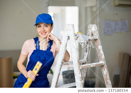 Female worker posing in apartment being renovated Female worker posing in apartment being renovated 137180554