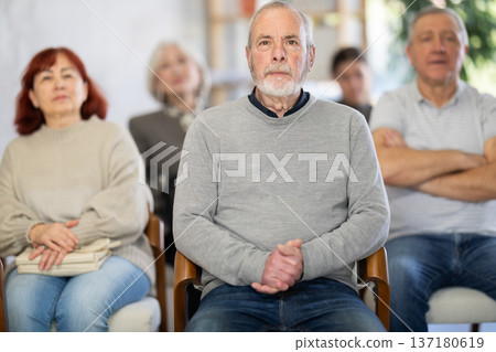 Elderly man listening and watching presentation 137180619