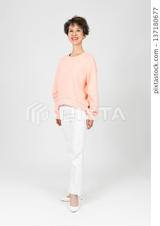 A woman in her 50s posing as a model on a white background A woman in her 50s posing as a model on a white background 137180677