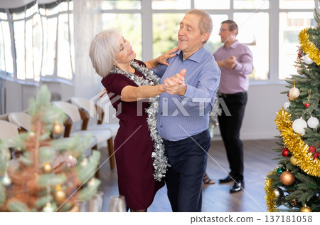 In studio decorated for New Year, elderly man and woman perky dance pair discofox. In studio decorated for New Year, elderly man and woman perky dance pair discofox. 137181058