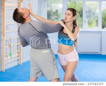 Woman and man practicing self defense techniques 137181157
