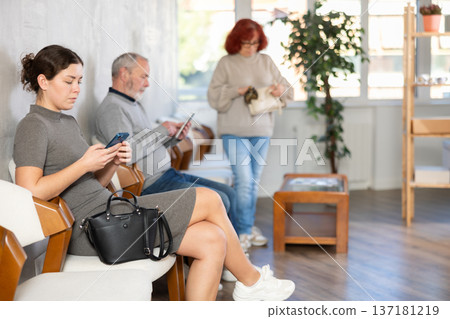 People of different ages sitting in clinic queue People of different ages sitting in clinic queue 137181219
