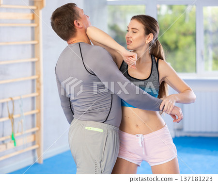 Woman and man practicing self defense techniques Woman and man practicing self defense techniques 137181223
