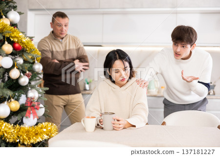 Adult and young man quarreling with young woman Adult and young man quarreling with young woman 137181227