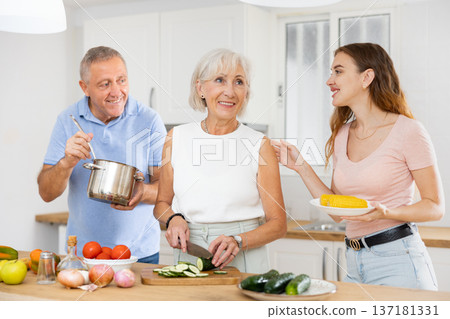 Happy smiling parents enjoy weekend cook Happy smiling parents enjoy weekend cook 137181331