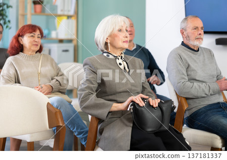 Elderly people watching presentation during an interactive group session Elderly people watching presentation during an interactive group session 137181337